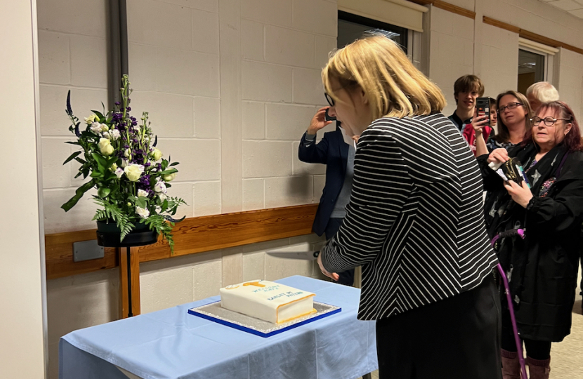 Rev Kate Wakeman-Toogood cuts the cake at her installation