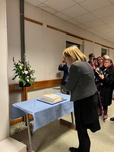 Rev Kate Wakeman-Toogood cuts the cake at her installation